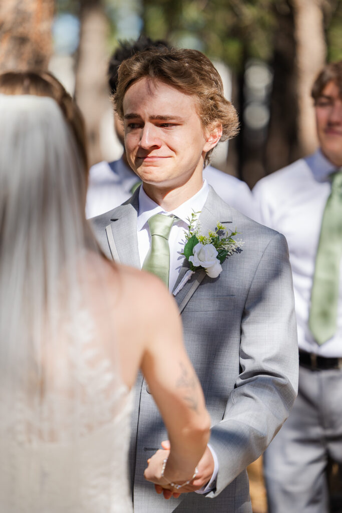 Groom tearing up seeing his bride for the first time. 
