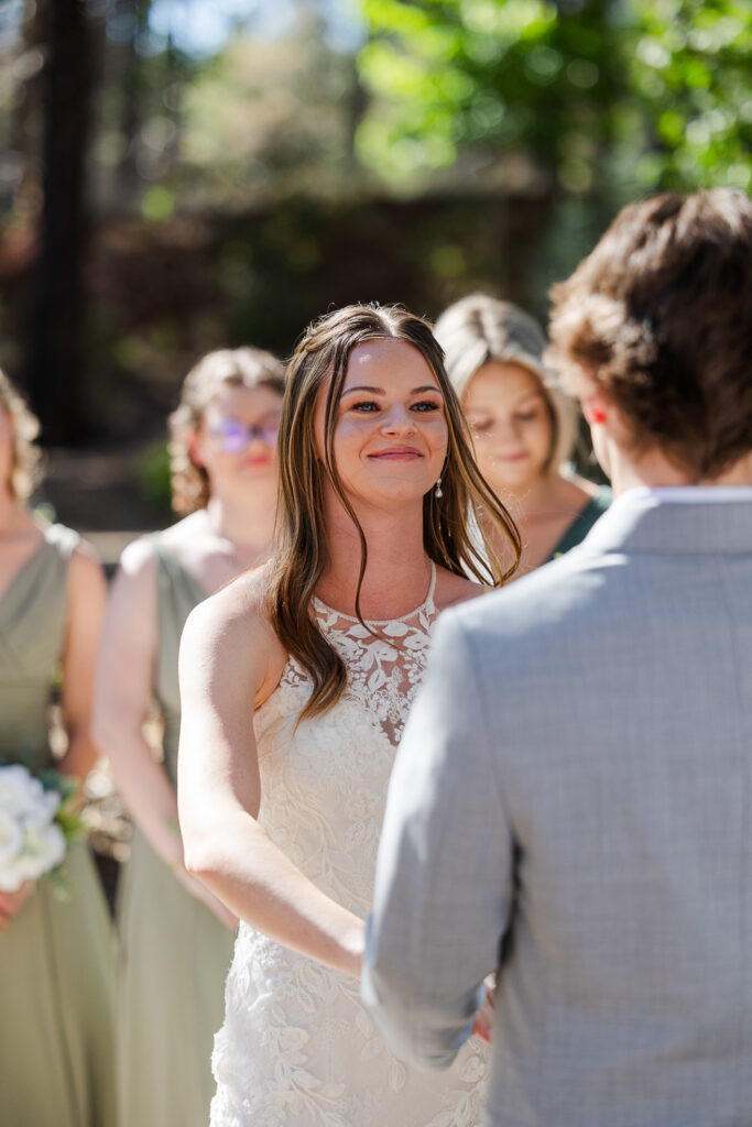 Bride staring at groom during their wedding ceremony at Serendipity in Flagstaff.