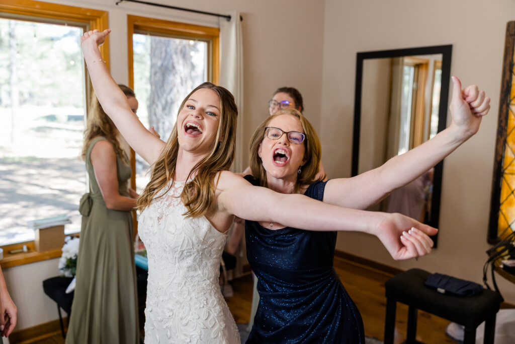Mom and bride celebrating after getting dress on in the bridal suite at Serendipity venue in Flagstaff. 